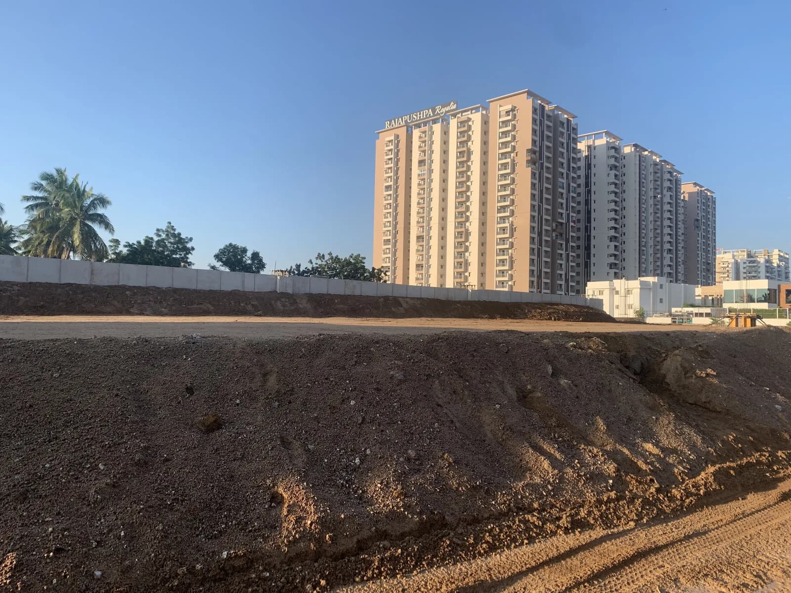 Levelled ground and a boundary wall, towers on the skyline
