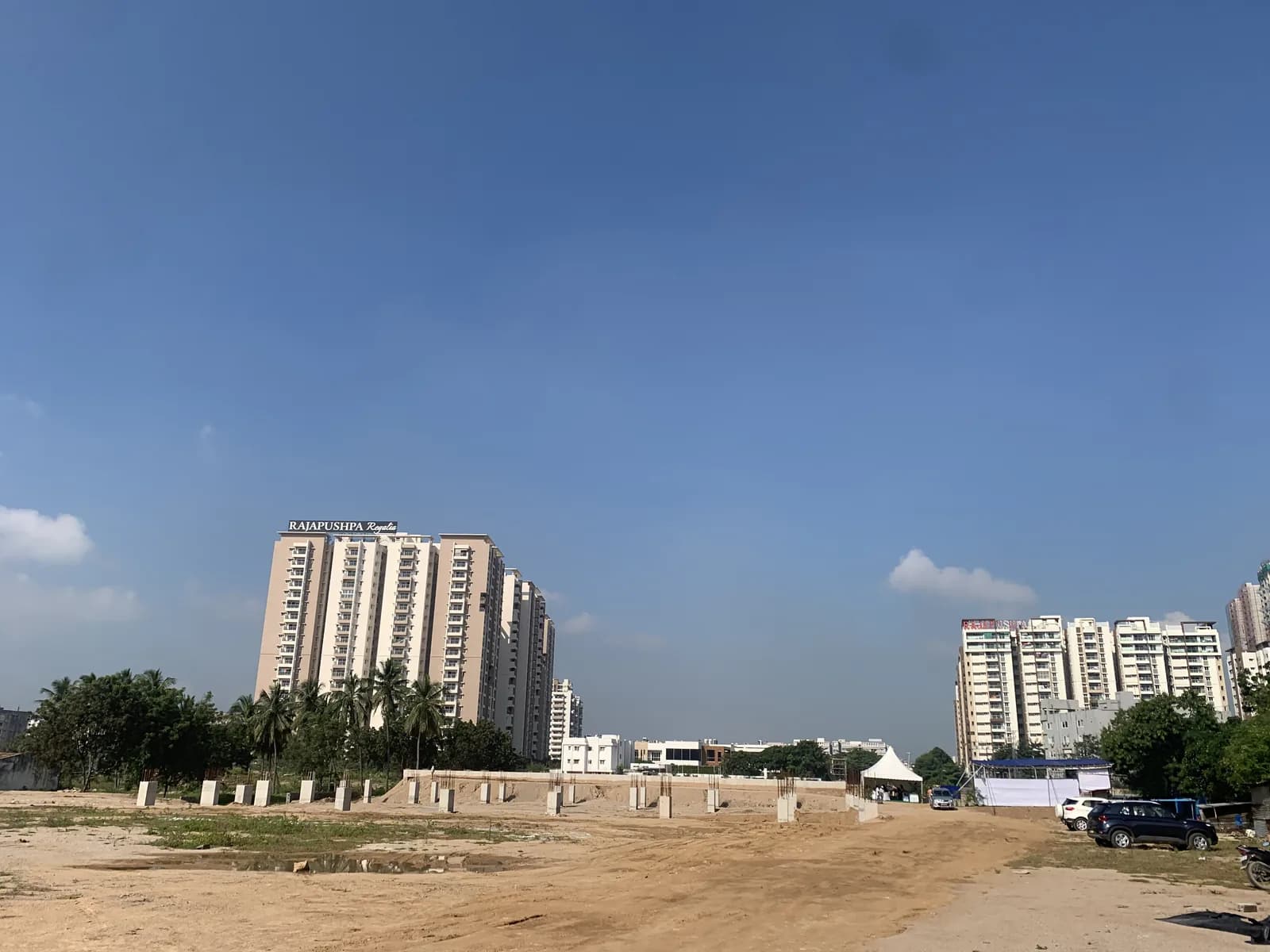 The site boundary with apartment towers standing behind