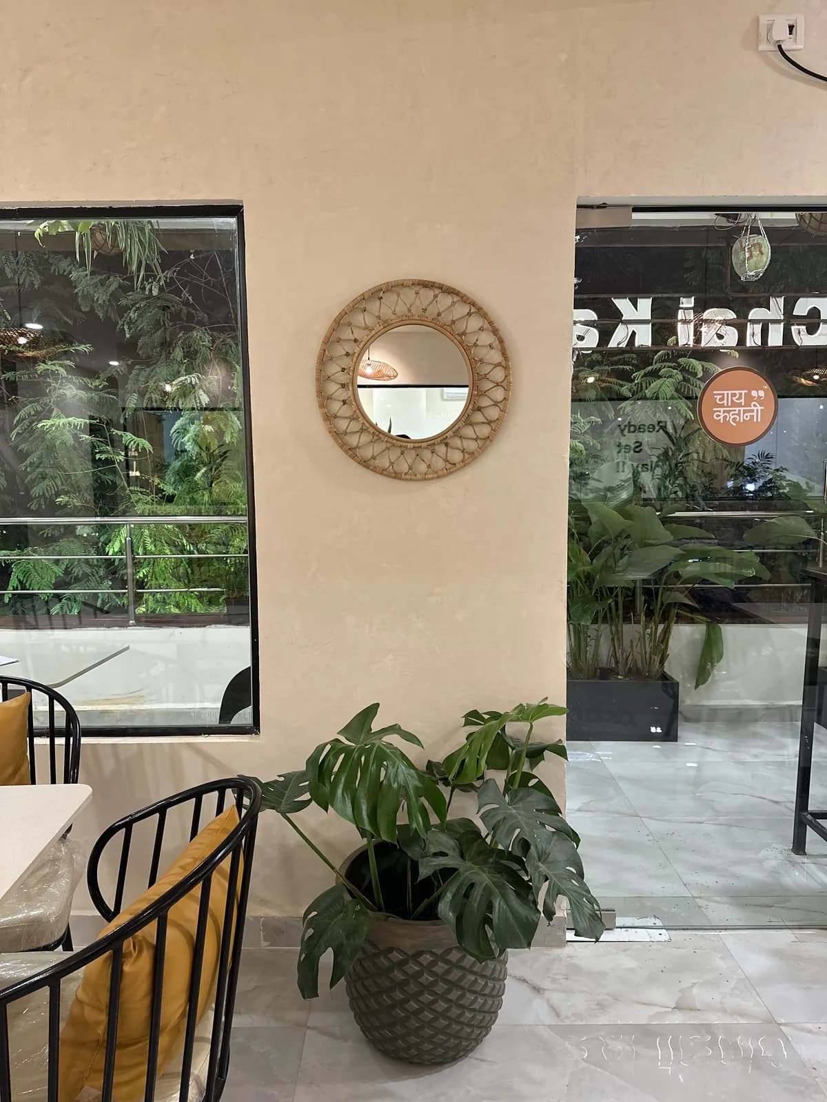 Corner seating beside potted planting and the glazed entrance