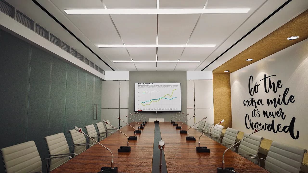 A boardroom with a long timber table and conference microphones below a coffered ceiling