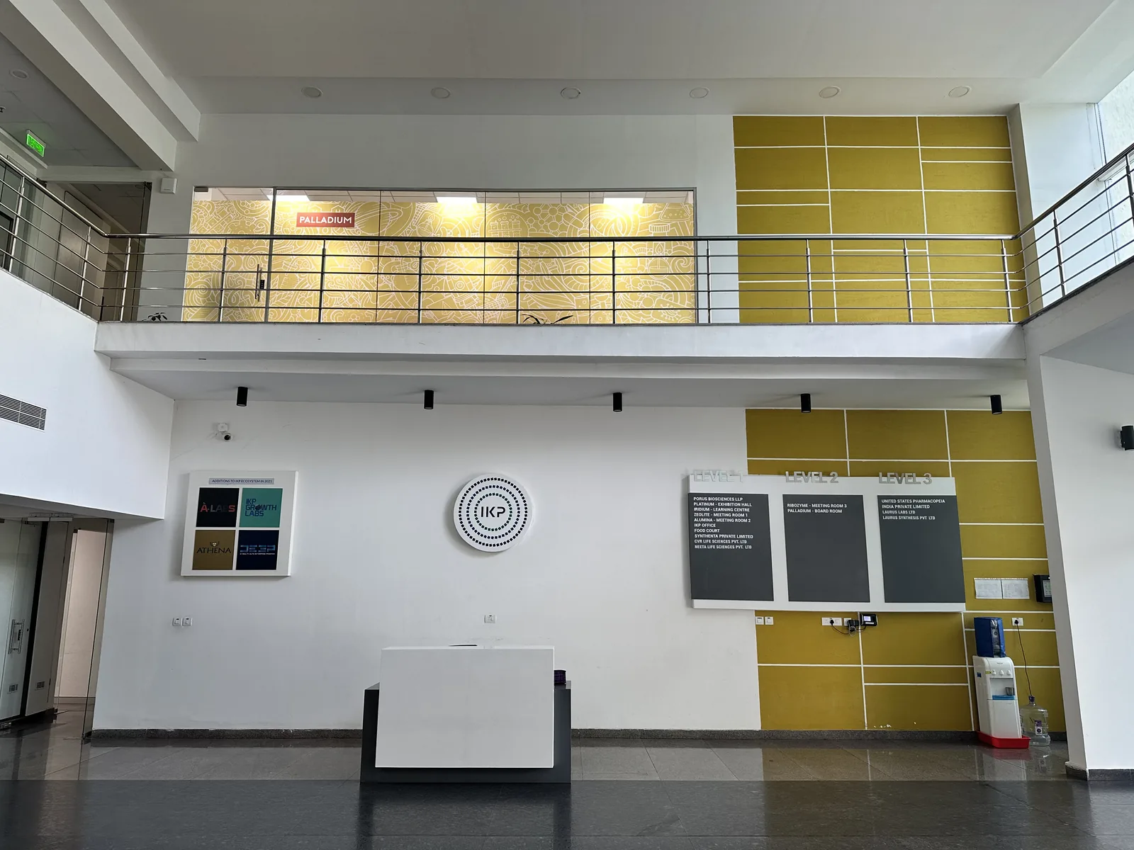 A full view of the double-height reception with the mezzanine above
