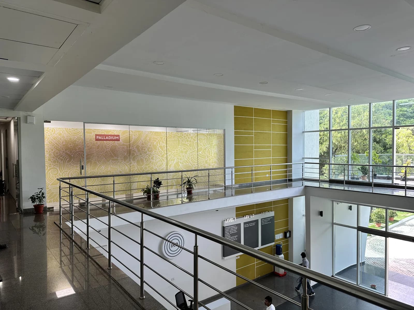 A mezzanine walkway looking down over the glazed atrium