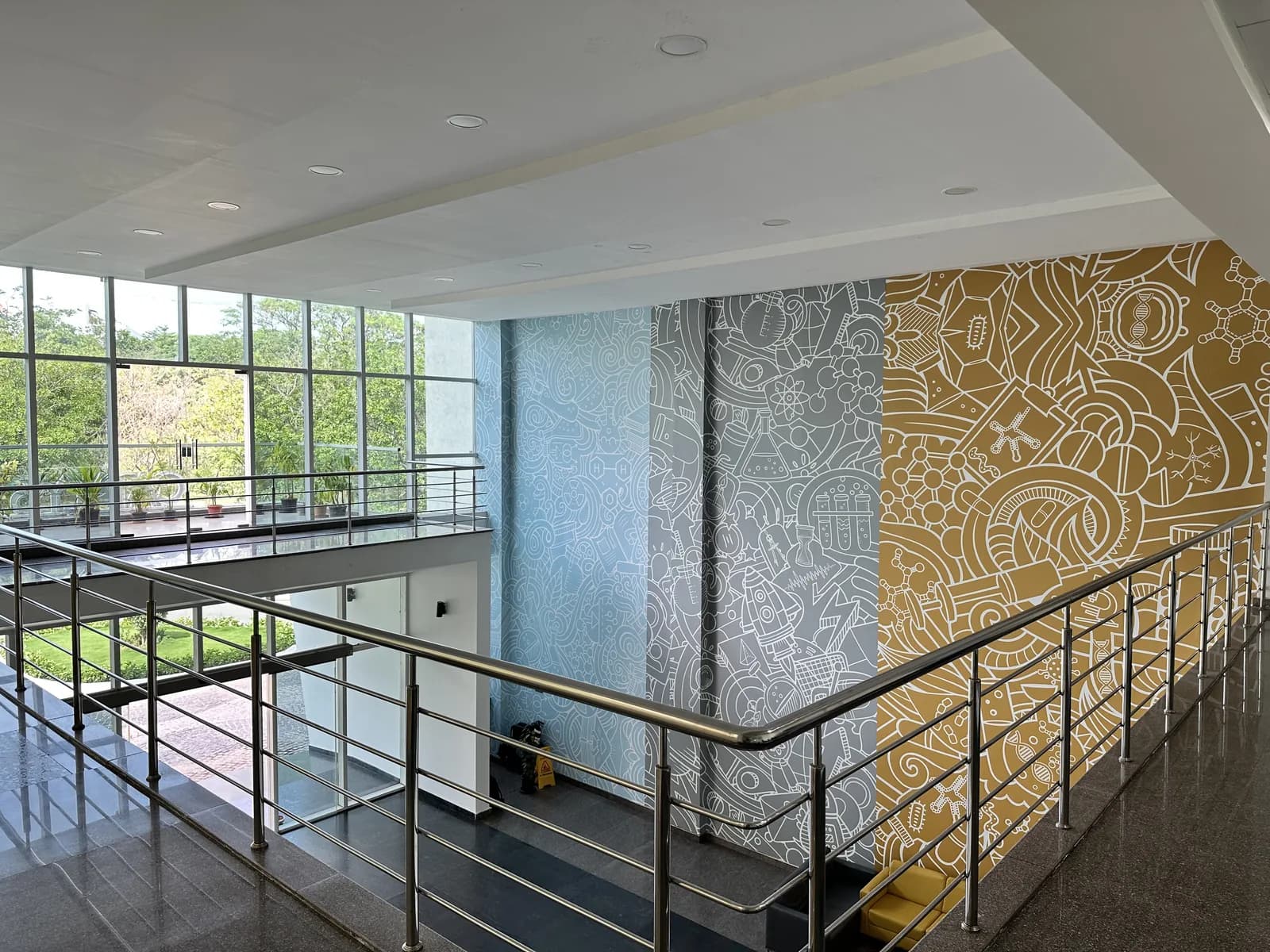 The mezzanine walkway beside the patterned atrium wall