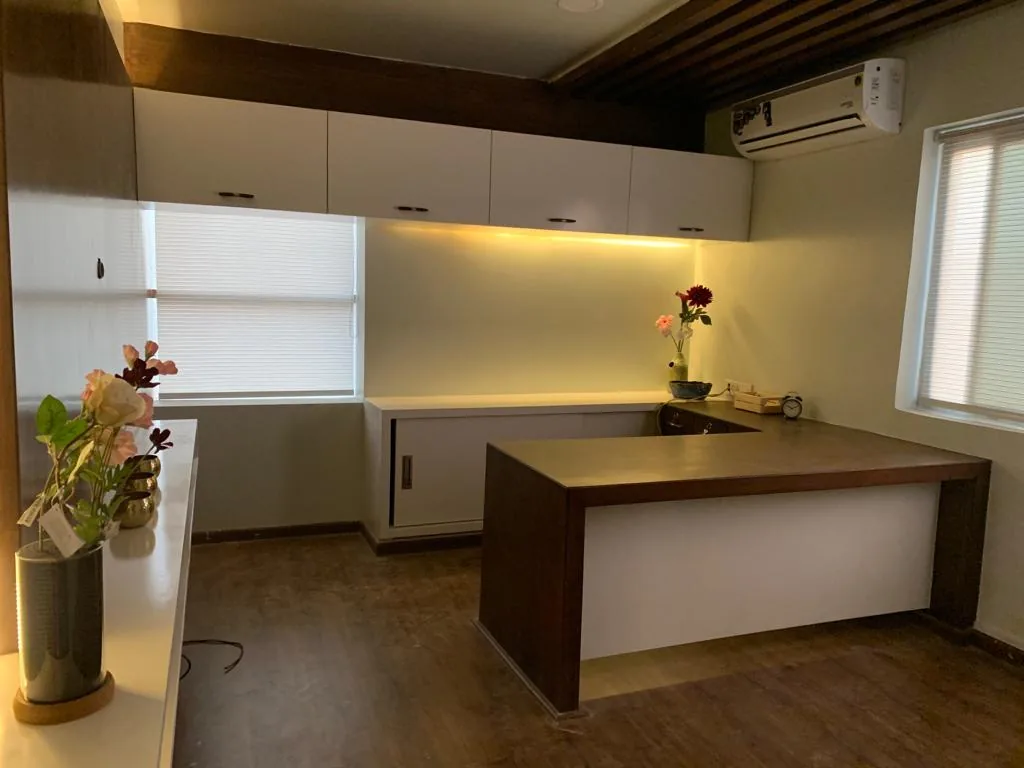 A desk and credenza under a timber-battened ceiling