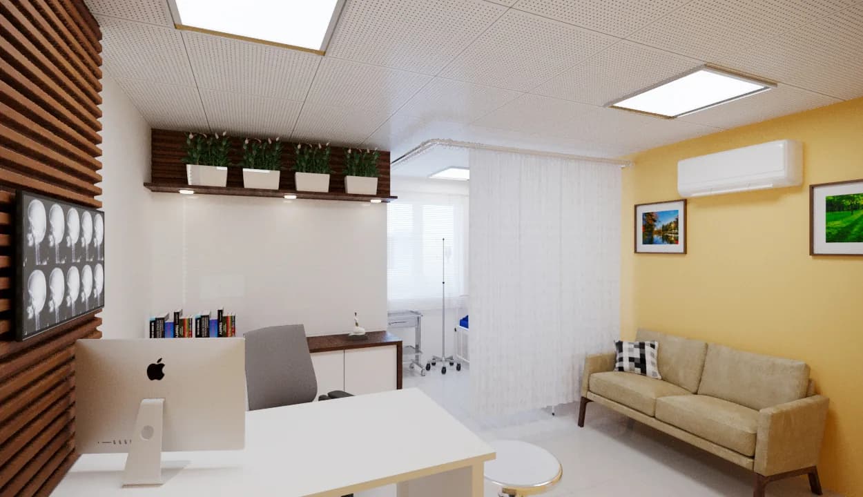 A consulting room in cream and ochre, beside a curtained treatment bay