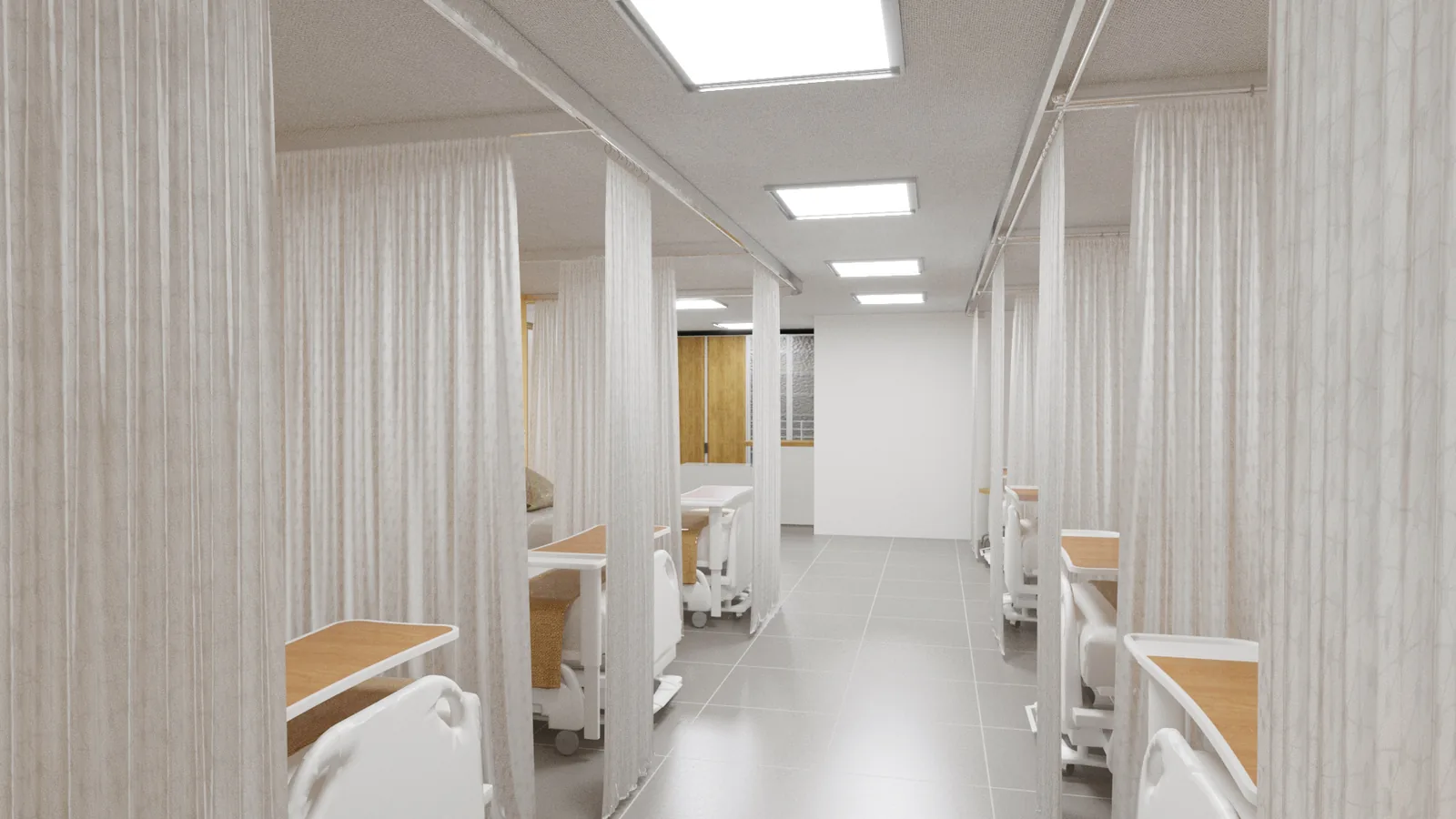 A ward corridor running between bays closed off by drawn white curtains