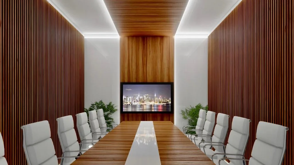 A boardroom lined in warm timber with white chairs and a screen at the far wall