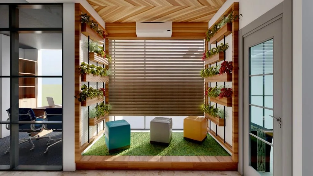 A breakout nook of low stools on turf, framed by planted timber shelving
