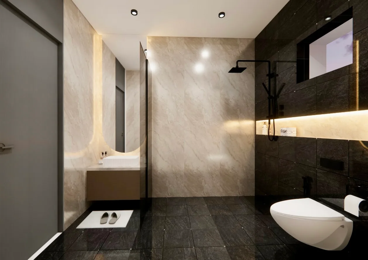 A bathroom in dark stone with a wall-hung basin and a backlit mirror