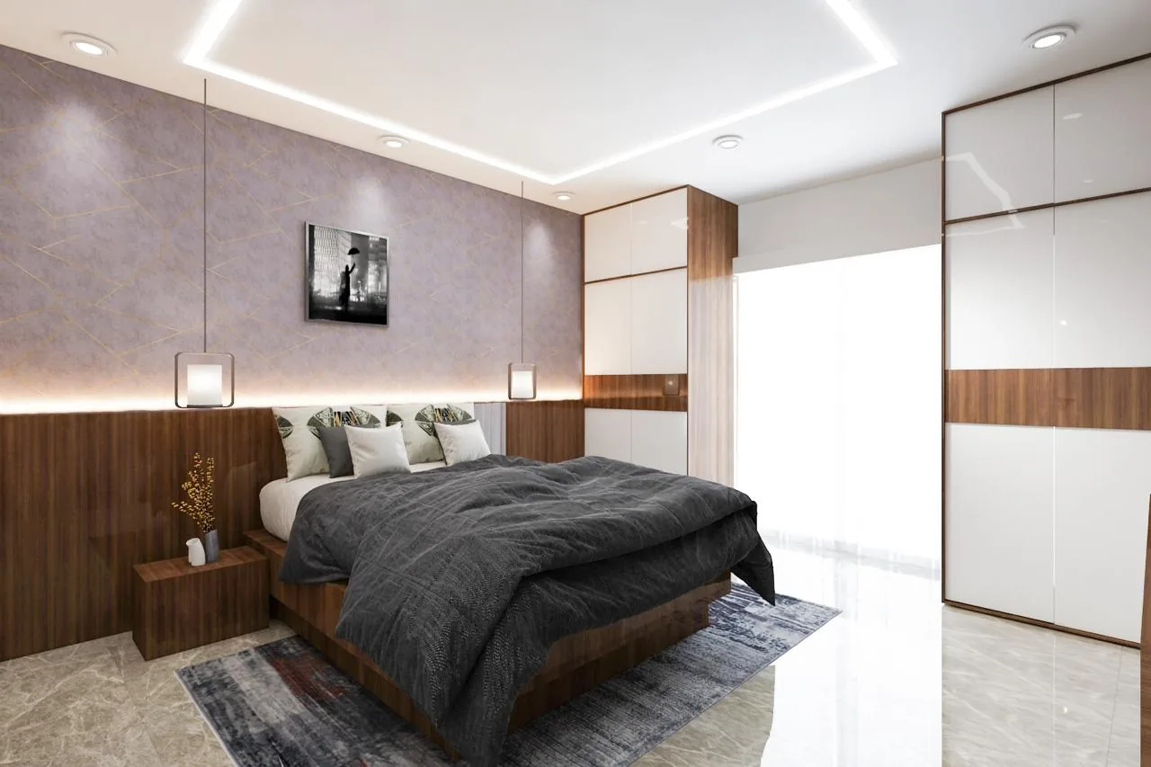 A bedroom with an upholstered head wall and a framed monochrome print above the bed