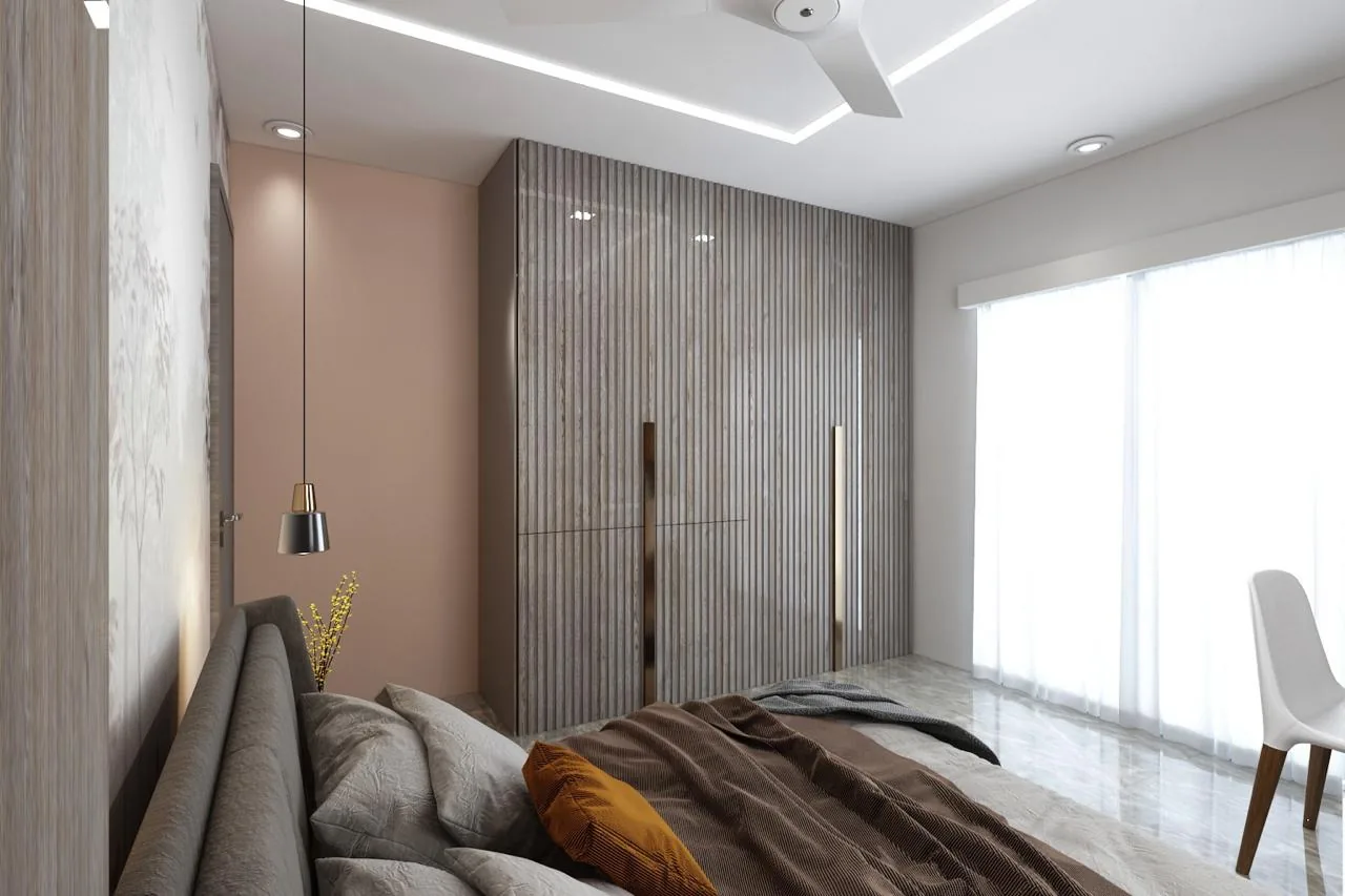 A fluted full-height wardrobe run seen from the bed, against a blush plaster wall