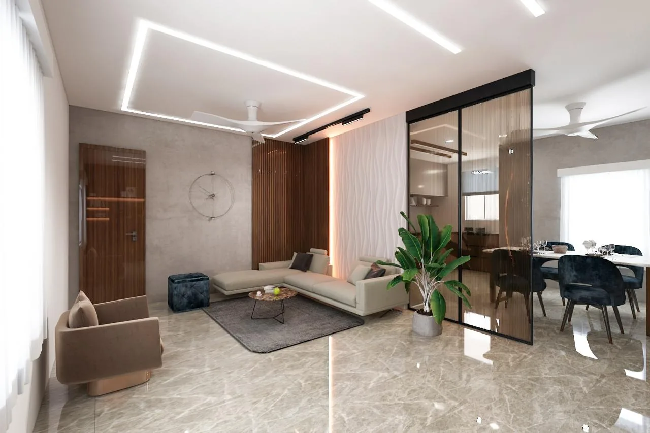 A living room with a low grey sectional on a marble floor, planting at the window