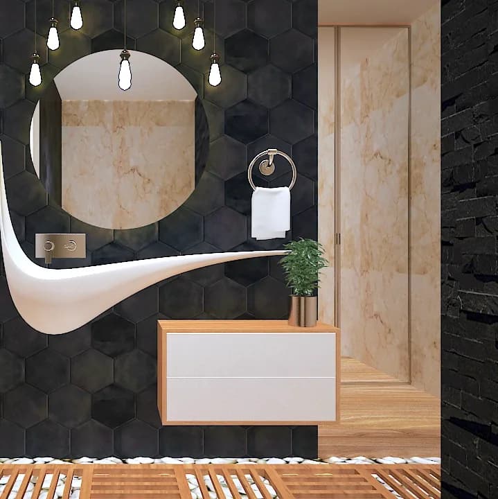 A bathroom in hexagonal dark tile, with a sculpted basin below a backlit ring mirror