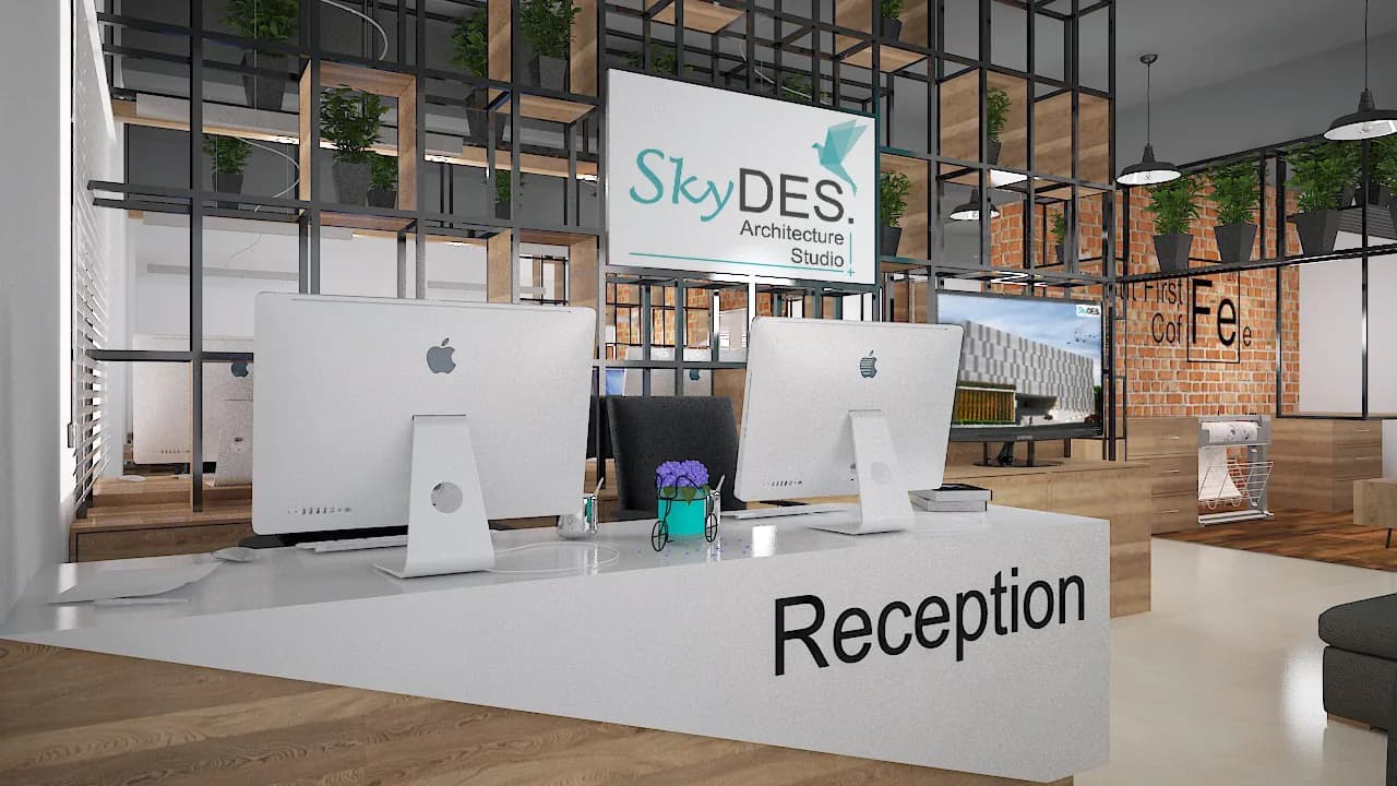 A white reception desk with monitors, below the studio sign set in a steel-framed screen