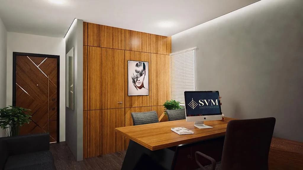 An office cabin panelled in timber, a desk and monitor below a framed print