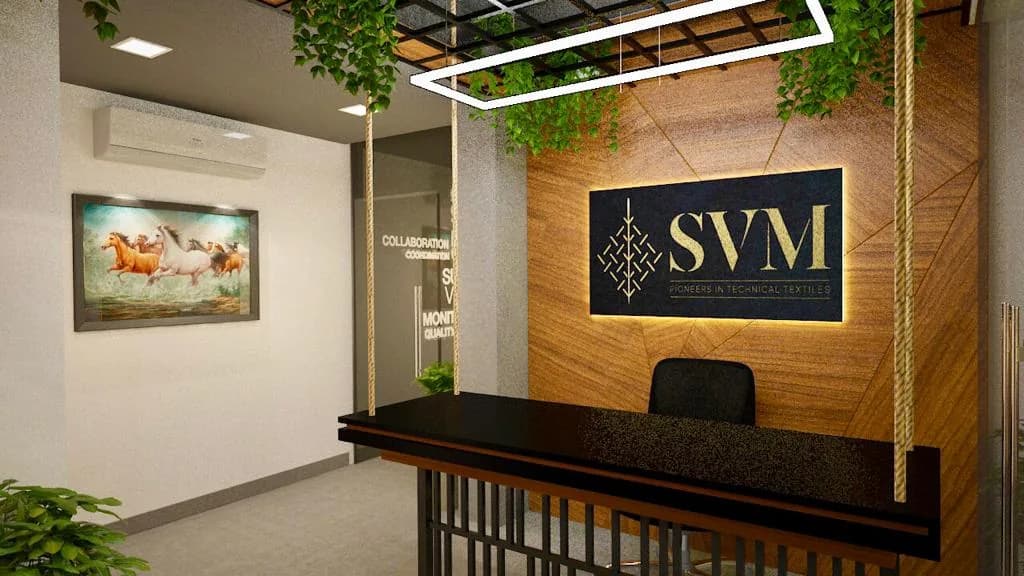 An office reception desk in dark stone below a lit brand wall in fluted timber