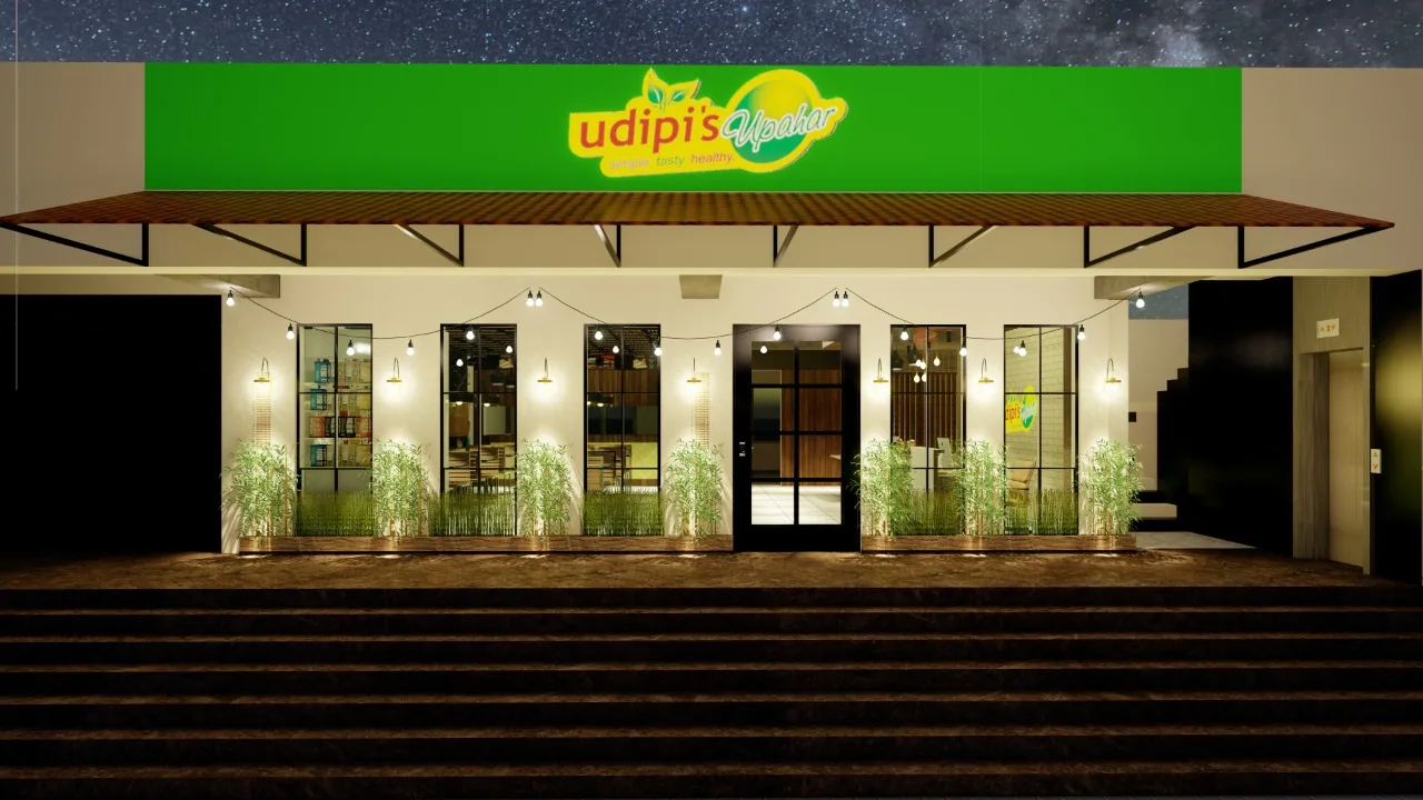 The restaurant shopfront at dusk, warm light behind full-height glazing