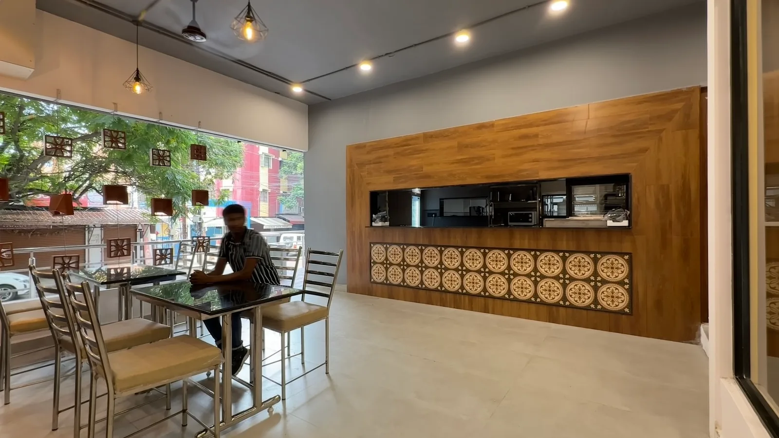 Counter seating facing the street glazing, with a timber servery beyond