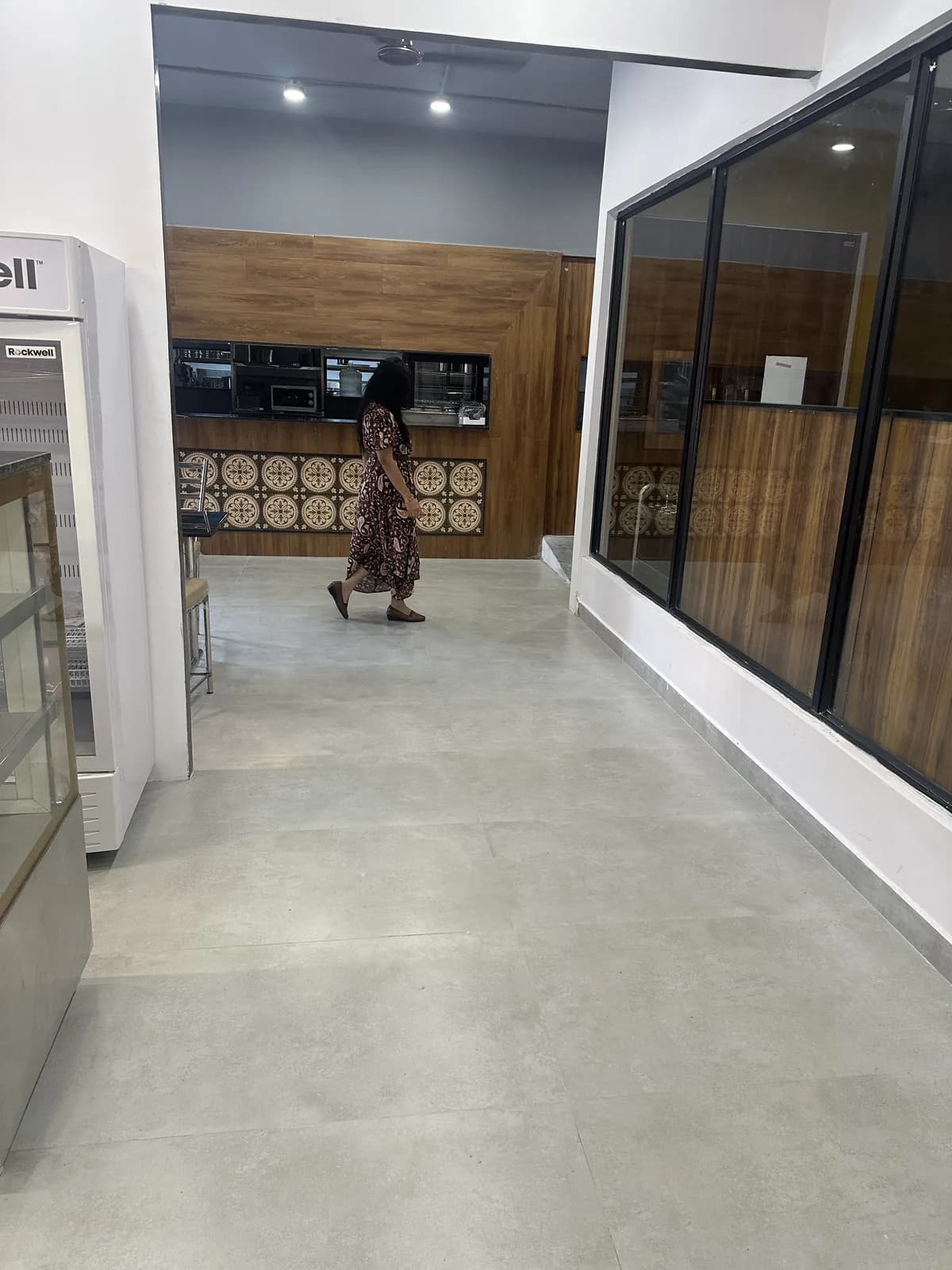 An entrance corridor in polished concrete leading toward the servery